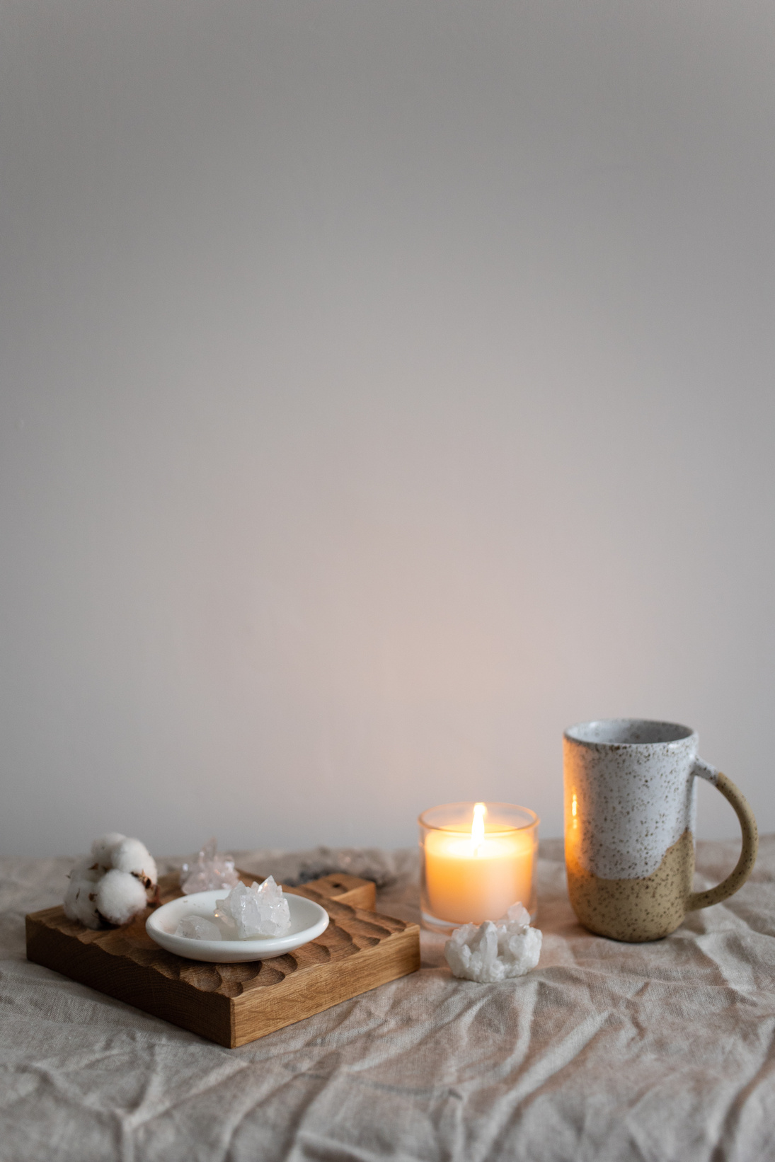 Mug Near Candle and Healing Crystals