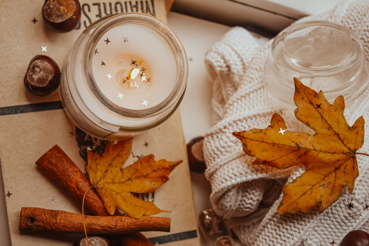 lighted Candle Beside Yellow Maple Leaves